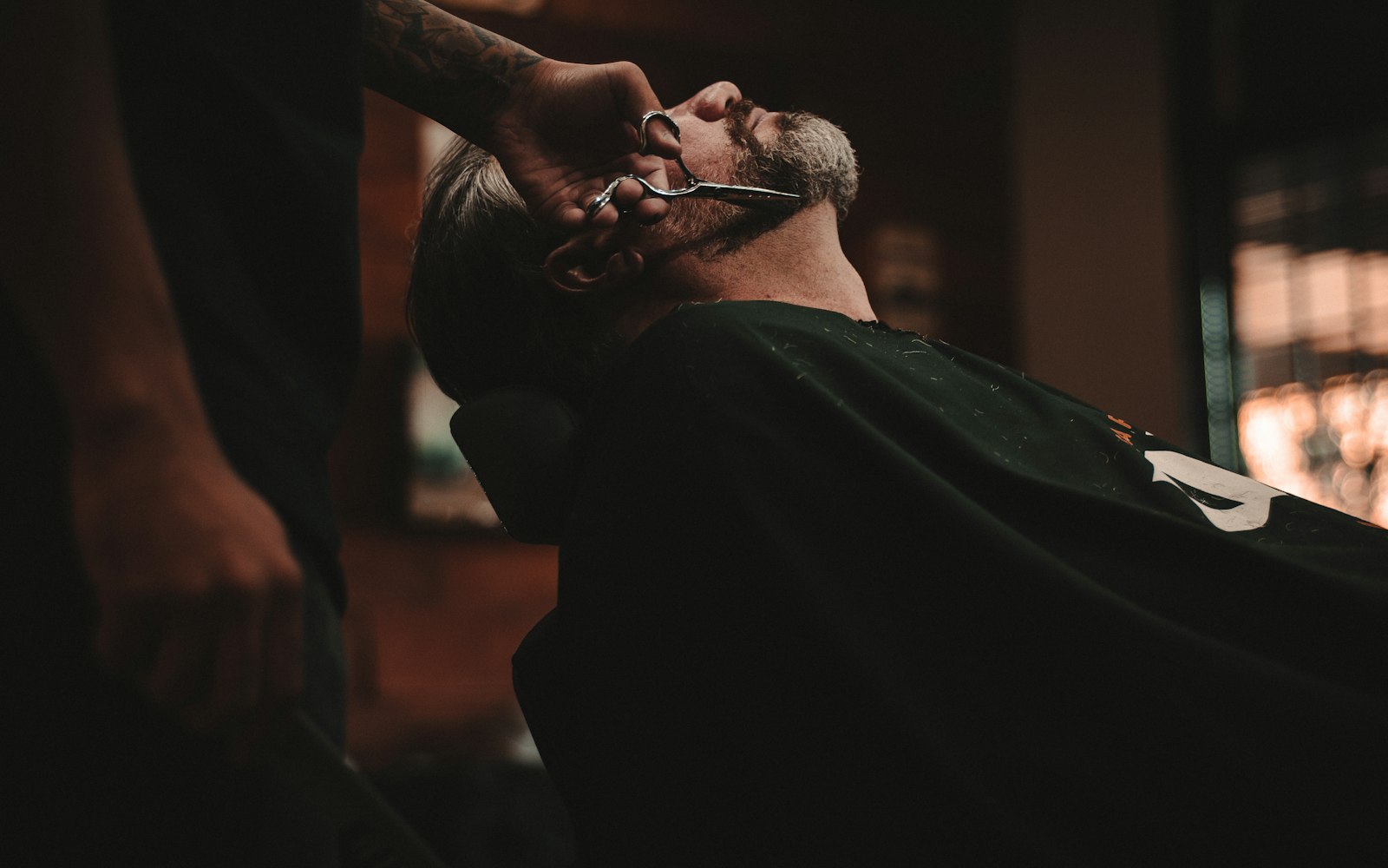 Barber shaving a client