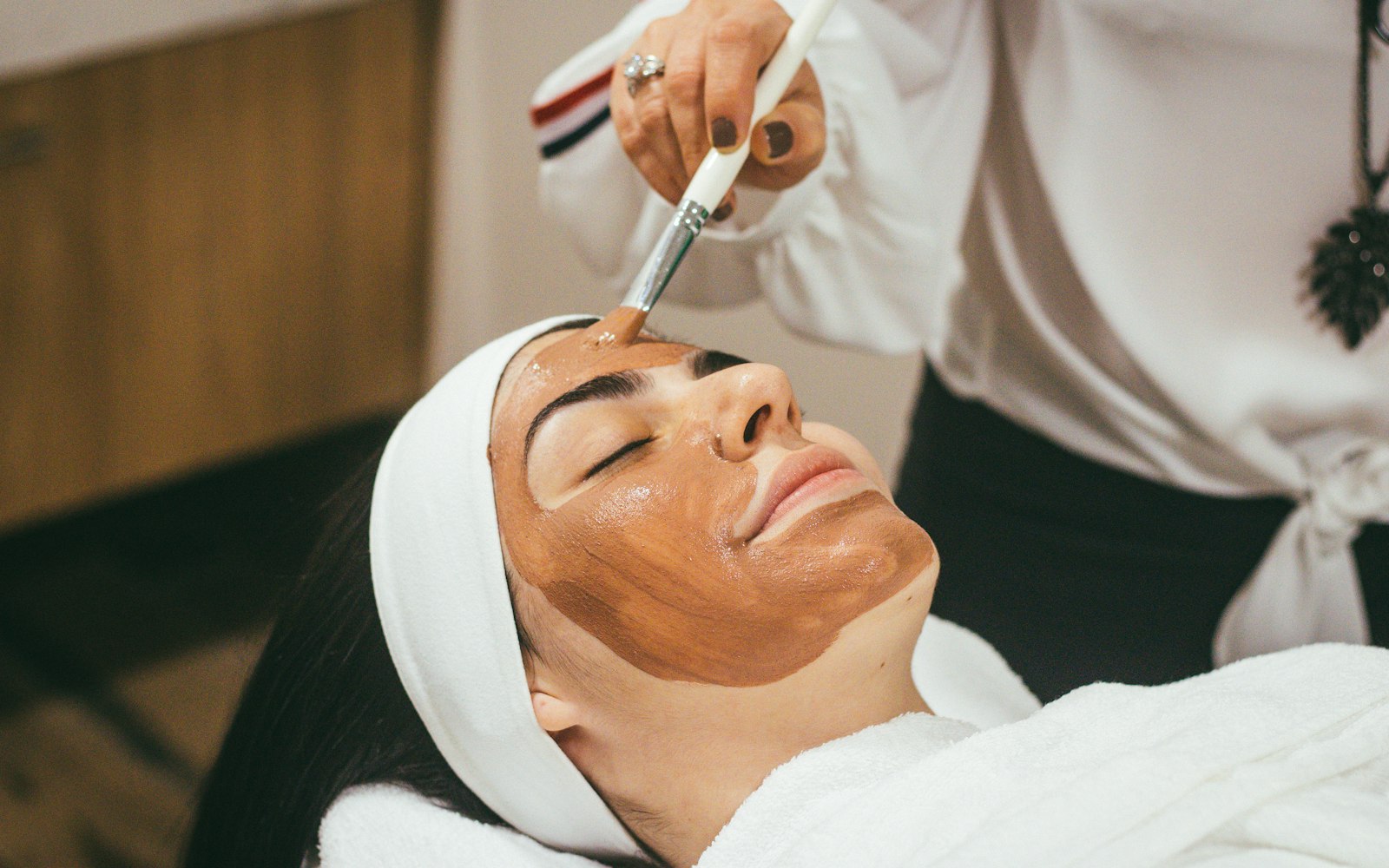 Esthetician performing a facial treatment